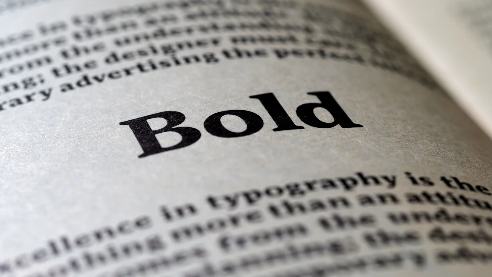 Printed book pages showing body text typography, representing choosing a book interior font