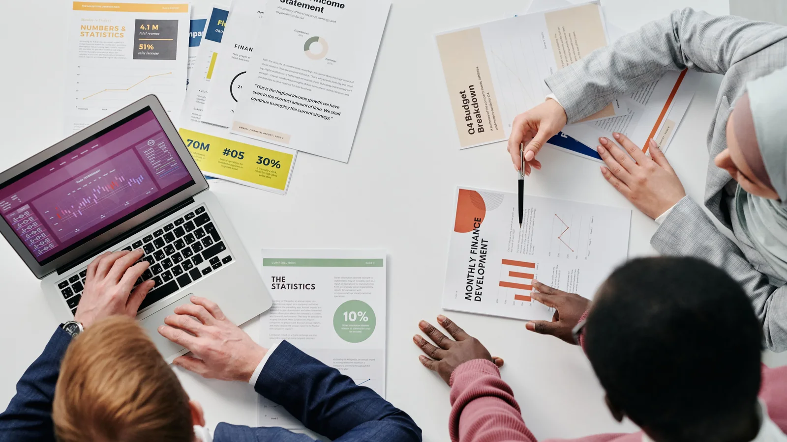 A team reviewing printed reports and charts, representing ESG and sustainability report design