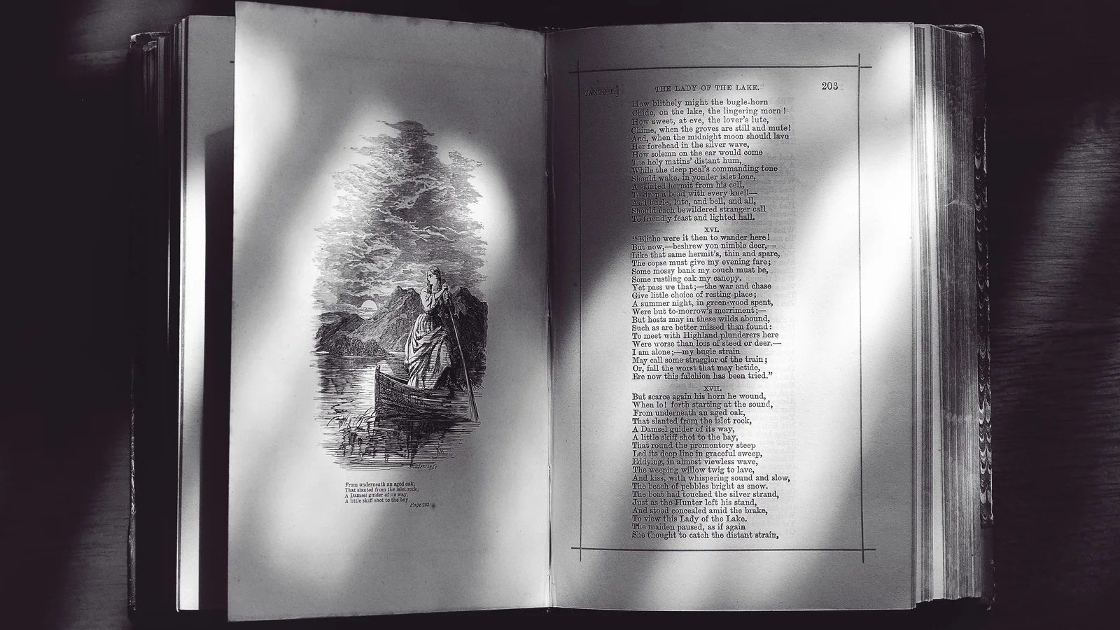 An open antique book showing a poem and an illustration, representing poetry book formatting