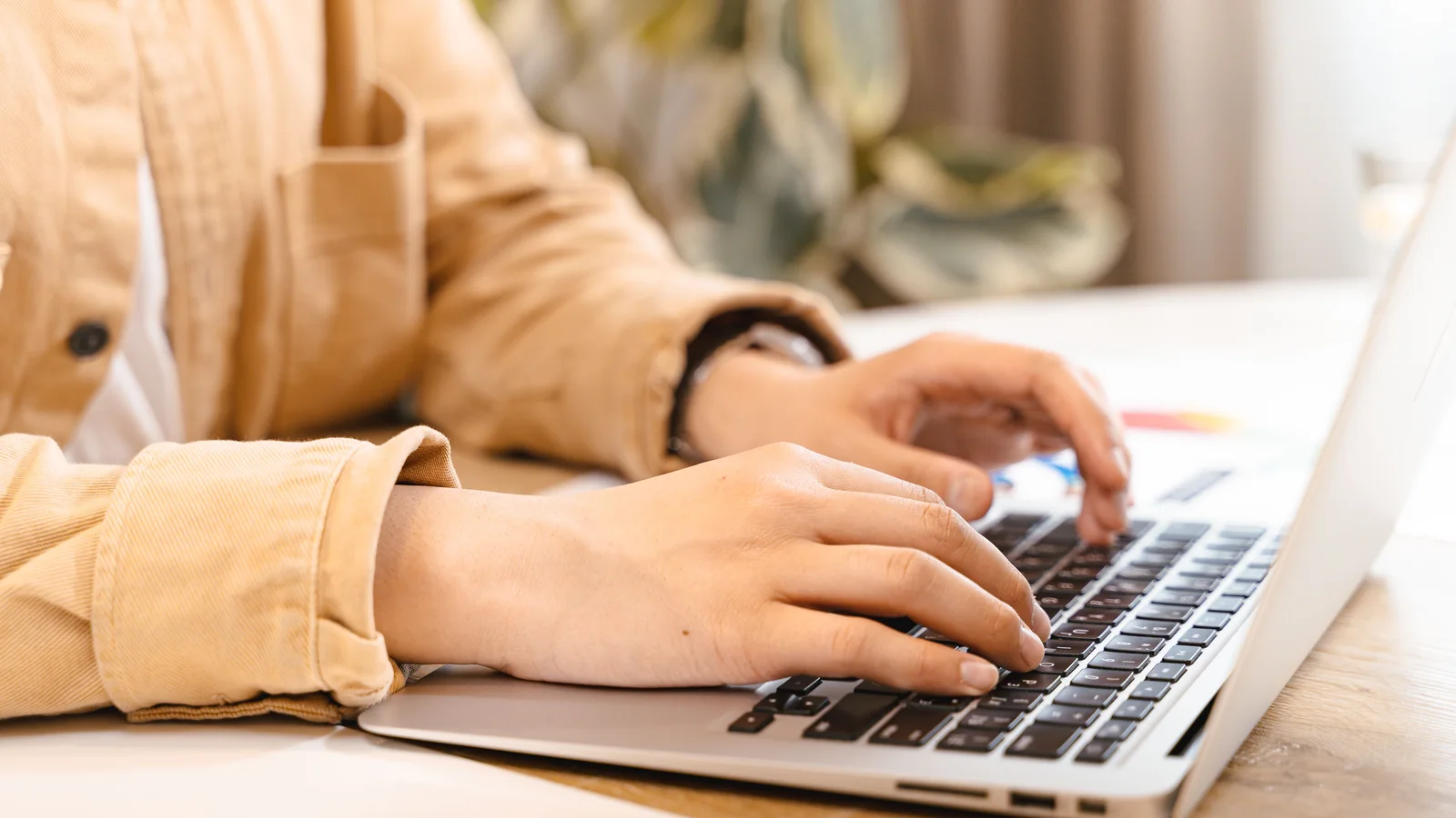 Hands typing on a laptop, representing preparing a manuscript before formatting